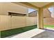 Charming covered patio and artificial turf in a fully fenced backyard at 7189 Ashcroft St, North Las Vegas, NV 89084
