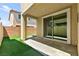 Covered patio with a slider and an artificial turf yard for outdoor enjoyment at 7189 Ashcroft St, North Las Vegas, NV 89084