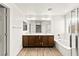 Bathroom featuring a double sink vanity, soaking tub, and wood-look floors at 7189 Ashcroft St, North Las Vegas, NV 89084