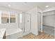 A full bathroom featuring a glass-enclosed shower and soaking tub at 7189 Ashcroft St, North Las Vegas, NV 89084