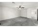 A bright, open bedroom with a ceiling fan, neutral paint, and soft gray carpet flooring at 7189 Ashcroft St, North Las Vegas, NV 89084