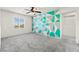 Bright bedroom with an eye-catching accent wall, ceiling fan, and a large window at 7189 Ashcroft St, North Las Vegas, NV 89084