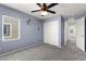 Comfortable bedroom with a fan, window views, and a large closet at 7189 Ashcroft St, North Las Vegas, NV 89084