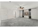 Spacious bonus room with a ceiling fan, plush carpeting, and an adjacent bathroom at 7189 Ashcroft St, North Las Vegas, NV 89084