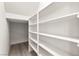 Spacious walk-in closet with built-in white shelving for ample storage at 7189 Ashcroft St, North Las Vegas, NV 89084