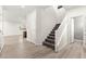 Inviting foyer with staircase, wood-look flooring, and neutral paint at 7189 Ashcroft St, North Las Vegas, NV 89084