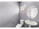 Well-lit powder room with a stylish round mirror and modern fixtures at 7189 Ashcroft St, North Las Vegas, NV 89084