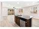 Kitchen with granite island and stainless dishwasher opens to living room and patio at 7189 Ashcroft St, North Las Vegas, NV 89084