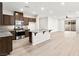 Open concept kitchen with stainless appliances, granite counters, and view into living area at 7189 Ashcroft St, North Las Vegas, NV 89084