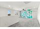Spacious loft area with an eye-catching accent wall, ceiling fan, and abundant natural light at 7189 Ashcroft St, North Las Vegas, NV 89084