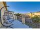 A cozy balcony featuring a hanging papasan chair with a view overlooking the neighboring yards at 7337 Savannah Falls St, Las Vegas, NV 89131