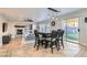 Cozy dining area with backyard access, a fireplace, and a modern light fixture at 7337 Savannah Falls St, Las Vegas, NV 89131