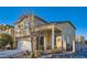 Two-story home with brick accents, a cozy front porch, and a landscaped yard at 7337 Savannah Falls St, Las Vegas, NV 89131