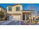 Charming two-story home with a well-maintained lawn, a two-car garage, and a welcoming front porch at 7337 Savannah Falls St, Las Vegas, NV 89131