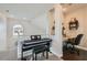 Hallway view with an electric piano, a home office nook, and a large window letting in natural light at 7337 Savannah Falls St, Las Vegas, NV 89131