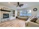 Comfortable living room with a stone fireplace, ample seating, and natural light at 7337 Savannah Falls St, Las Vegas, NV 89131