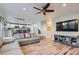 Open-concept living room featuring hardwood floors, modern furnishings, and a ceiling fan at 7337 Savannah Falls St, Las Vegas, NV 89131