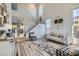 Spacious living room with a staircase, large windows, and contemporary furnishings at 7337 Savannah Falls St, Las Vegas, NV 89131