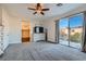 Bright main bedroom with walk-in closet, balcony access, and ceiling fan at 7337 Savannah Falls St, Las Vegas, NV 89131