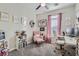 Stylish home office with pink accents, work desk, and carpet flooring at 7337 Savannah Falls St, Las Vegas, NV 89131