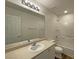 Bright bathroom features a vanity, mirror, and tub with shower at 7412 Bewitching Ct, Las Vegas, NV 89149