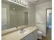 Bright bathroom featuring a vanity, mirror, and tiled shower at 7412 Bewitching Ct, Las Vegas, NV 89149