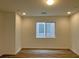 Bright bedroom with recessed lighting, fresh paint, and new laminate flooring at 7412 Bewitching Ct, Las Vegas, NV 89149