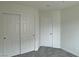 Bedroom features closet with sliding doors and neutral carpet at 7412 Bewitching Ct, Las Vegas, NV 89149