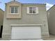 Two-story home featuring a large garage and beige and gray stucco at 7412 Bewitching Ct, Las Vegas, NV 89149