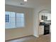 Well-lit kitchen featuring white cabinets, laminate flooring and modern appliances at 7412 Bewitching Ct, Las Vegas, NV 89149