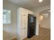 Bright kitchen features white cabinets, modern black refrigerator, and wood-style flooring at 7412 Bewitching Ct, Las Vegas, NV 89149