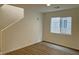 Inviting living room boasts new laminate flooring, fresh paint and stairwell access at 7412 Bewitching Ct, Las Vegas, NV 89149