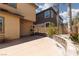 Spacious backyard featuring a large concrete area, low stone wall, secure fencing and lush plants for outdoor activities at 7736 Villa Andrade Ave, Las Vegas, NV 89131