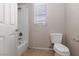 Bathroom with tile flooring, shower-tub combo, toilet and white walls at 7736 Villa Andrade Ave, Las Vegas, NV 89131