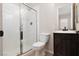 This bathroom has a walk-in shower, toilet, and a dark wood vanity with a sink at 7736 Villa Andrade Ave, Las Vegas, NV 89131