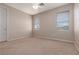 Neutral bedroom featuring two large windows for natural light and a ceiling fan at 7736 Villa Andrade Ave, Las Vegas, NV 89131