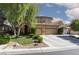 Charming two-story home with landscaped yard, mature tree and a spacious two-car garage and large driveway at 7736 Villa Andrade Ave, Las Vegas, NV 89131