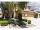 Two-story home with manicured landscaping, green lawn, and inviting curb appeal at 7736 Villa Andrade Ave, Las Vegas, NV 89131