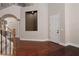 Open foyer showcasing hardwood floors, a staircase, and a unique architectural niche at 7736 Villa Andrade Ave, Las Vegas, NV 89131