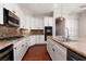 The kitchen is adorned with granite countertops, stainless steel appliances, and white cabinets at 7736 Villa Andrade Ave, Las Vegas, NV 89131