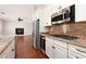 Well-equipped kitchen featuring granite countertops and modern stainless steel appliances at 7736 Villa Andrade Ave, Las Vegas, NV 89131