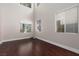 Sun-lit living area featuring hardwood floors, large windows, and neutral wall colors at 7736 Villa Andrade Ave, Las Vegas, NV 89131