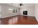 Open living room with fireplace, wood floors, and many windows, offers a cozy space at 7736 Villa Andrade Ave, Las Vegas, NV 89131