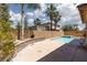 Sparkling backyard pool and spa surrounded by a concrete patio and lush landscaping, perfect for relaxing and entertaining at 7736 Villa Andrade Ave, Las Vegas, NV 89131