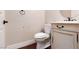 Cozy powder room features a toilet and a small vanity with a round mirror at 7736 Villa Andrade Ave, Las Vegas, NV 89131
