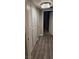 Hallway with floor-to-ceiling cabinets, modern lighting, and fresh flooring, offering ample storage and style at 8070 W Russell Rd # 1105, Las Vegas, NV 89113