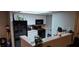 Well-equipped kitchen featuring white cabinetry, black appliances, and breakfast bar at 8070 W Russell Rd # 1105, Las Vegas, NV 89113