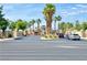 Welcoming community entrance with decorative gates, palm trees, and manicured landscaping at 8070 W Russell Rd # 2070, Las Vegas, NV 89113
