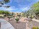 Well-manicured landscaping surrounds the building, complemented by winding sidewalks and mature trees at 8070 W Russell Rd # 2070, Las Vegas, NV 89113