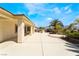 Spacious covered back patio with an outdoor kitchen and landscaped yard at 8236 Imperial Lakes St, Las Vegas, NV 89131